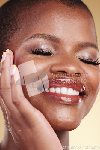 Image of Beauty, makeup and a happy woman with hand on face for self care, skin glow and cosmetics. Closeup of african person or model with facial shine, eyelash extension and a smile on a studio background