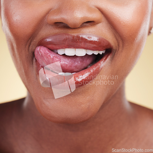 Image of Woman, lips and tongue out, natural beauty and cosmetics, skin and closeup isolated on studio background. Smile, lipstick and makeup with skincare, shine and dermatology, lick and playful with fun