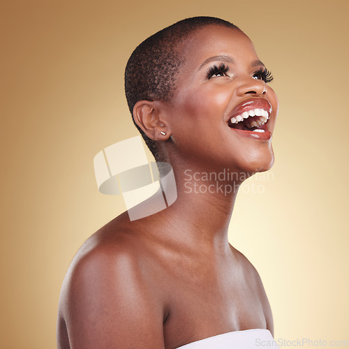 Image of Beauty, makeup and a black woman laughing in studio for skin care, glow and funny cosmetics. Face of a happy african model person with facial shine, dermatology and wellness on a beige background