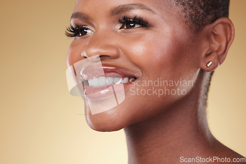 Image of Beauty, makeup and face of a happy black woman in studio for self care, skincare and cosmetics. Closeup of African aesthetic model person with facial shine, teeth smile and glow on a beige background