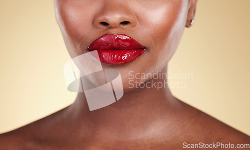 Image of Red, lipstick and woman, beauty and makeup with closeup, skin and shine isolated on studio background. Bold cosmetic product, lips and cosmetology with elegance and glamour with color and glow