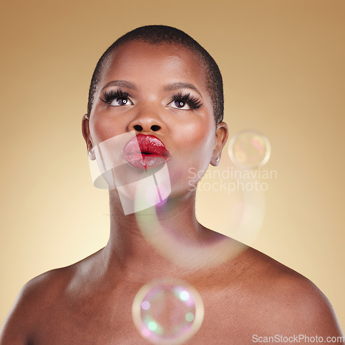 Image of Luxury, makeup and bubbles with face of black woman in studio for cosmetics, spa treatment and beauty. Skincare, dermatology and self care with model on gold background for glow, facial and soap