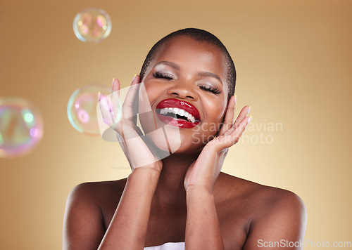 Image of Beauty, makeup and bubbles with face of black woman in studio for cosmetics, spa treatment and luxury. Skincare, dermatology and self care with model on gold background for glow, facial and soap