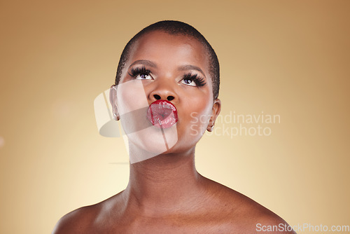 Image of Red, lipstick and black woman, beauty and kiss, makeup and face isolated on studio background. Bold cosmetic product, lips and pout, elegant African model and glamour, headshot with color and glow