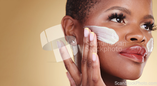 Image of Skincare, application and face cream for black woman in studio for dermatology or cosmetic results on brown background. Beauty, hand and model with facial, sunscreen or collagen, mask or application