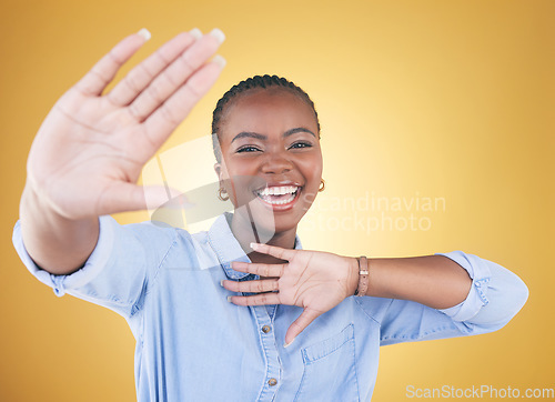 Image of Hands, frame and portrait of black woman on yellow background for confidence, creativity and beauty. Photography, perspective and face of African person with cosmetics, makeup and glamour in studio