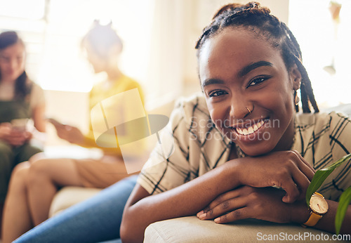Image of Happy, smile and portrait of black woman relaxing in living room with her friends in her modern apartment. Face, positive and young African female person sitting in the lounge for rest at her home.