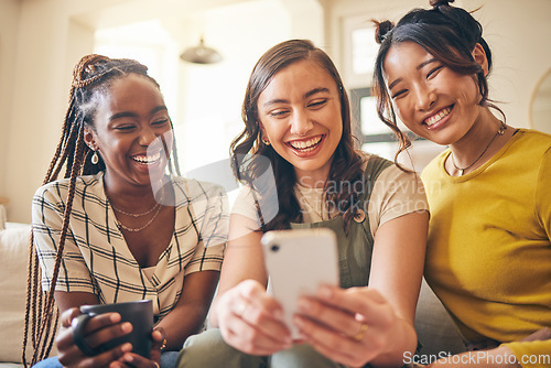 Image of Young women, comedy online and smartphone, friends relax at home with social media and communication. Gen z, happiness and funny meme, chat and using phone with people on couch, mobile app and tech