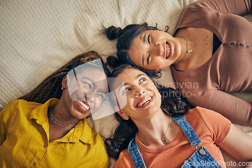 Image of Group of women, friends on bed with smile and bonding in living room together from above. Happiness, care and friendship, girls relax in bedroom with diversity, pride and people in home with fun.