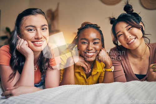 Image of Portrait of women, friends on bed with smile and bonding in apartment together in support, trust and solidarity. Relax, love and friendship, girls in bedroom with diversity, pride and people in home.