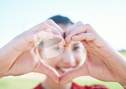 Image of Heart shape, closeup and hands of woman with a care, sweet and cute gesture outdoor on a field. Happy, smile and zoom of a young female person with a love sign or emoji in a outside park or garden.