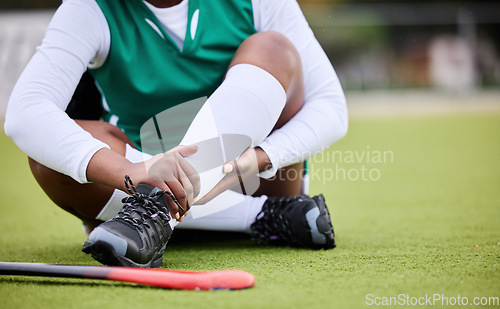 Image of Hockey, pain and leg injury by woman player on a field with problem, joint or muscle crisis in sport. Hand holding, ankle and athlete with emergency, inflammation or fitness accident from training