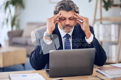 Image of Stress, headache and businessman on a laptop in the office while working on a corporate project. Migraine, burnout and mature professional male lawyer doing research on a computer in the workplace.