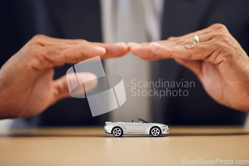 Image of Desk, hands and a person with car insurance or covering for safety or business. Office, investment and a man with a shelter or security for transportation, guarantee or premium support for a vehicle