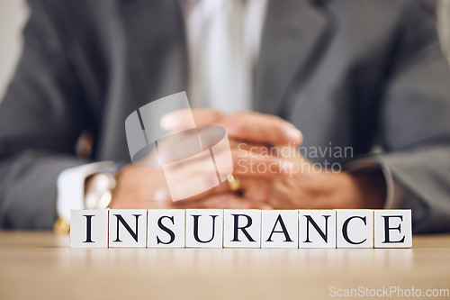 Image of Business person, hands and blocks for insurance, financial advisor or accounting on office desk. Letter or word of finance accountant, lawyer or real estate agent for investment, loan or bank cover