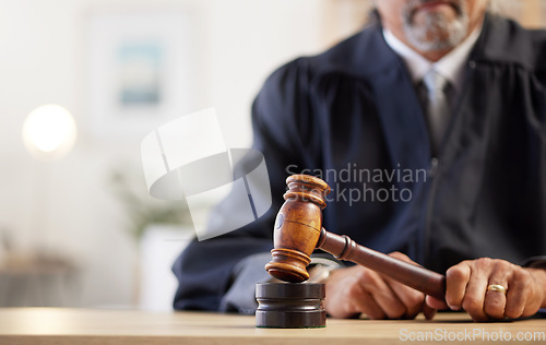 Image of Closeup, hands and judge with a gavel of law, rule for order and attention to justice with legal hearing. Zoom, person and lawyer with a hammer, decision and auction with constitution in courtroom