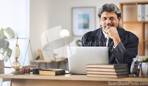 Image of Justice, man and portrait in office with laptop for working in law firm, court research or search online for legal policy or rules. Judge, attorney or mature businessman in communication on computer