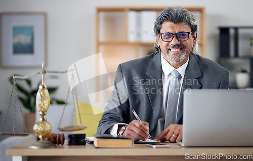 Image of Justice, lawyer and portrait in office with laptop for working in law firm, court research or search online for legal policy or rules. Judge, attorney or mature businessman review report on computer