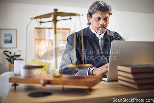 Image of Scales, justice and man in office with laptop for working in law firm, court research or search online for legal policy or rules. Judge, attorney or mature businessman with communication on computer