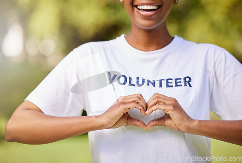 Image of Heart, hands and volunteer smile with sign for care, support and charity outdoor in nature, forest or environment. Show, love and happy person volunteering in community or service with empathy