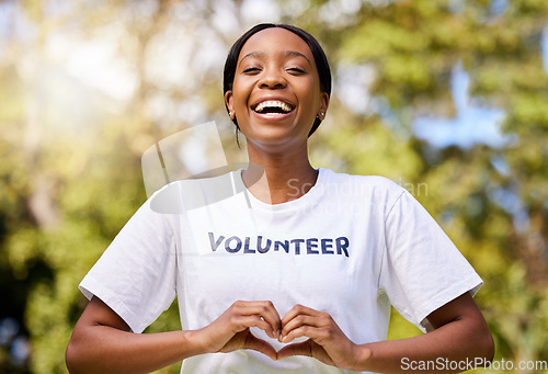 Image of Heart, hands and African volunteer woman with sign for care, support and charity outdoor in nature, forest or environment. Show, love and happy person helping in community or service with empathy