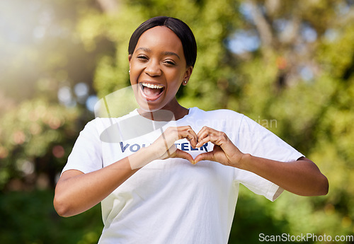 Image of Heart, hands and portrait of volunteer woman with sign for care, support and charity outdoor in nature, forest or environment. Show, love and happy person volunteering in community service in empathy