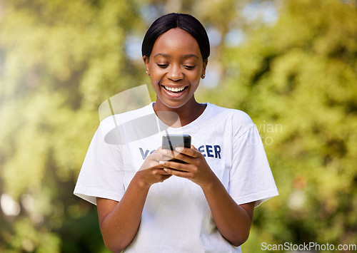 Image of Chat, park volunteering and black woman with a phone for social media, email or communication. Happy, web and African volunteer or charity worker in nature for cleaning with a mobile for notification