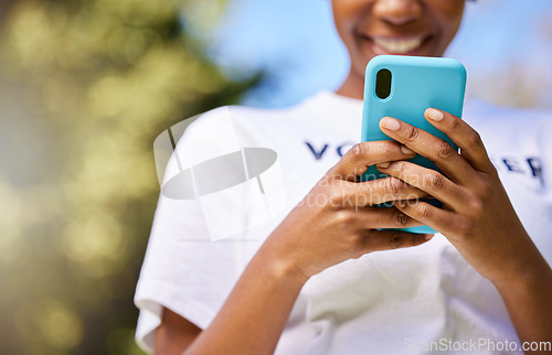 Image of Black woman, phone and hands typing in nature for communication, social media or outdoor networking. Closeup of happy African female person smile in chatting or texting on mobile smartphone app