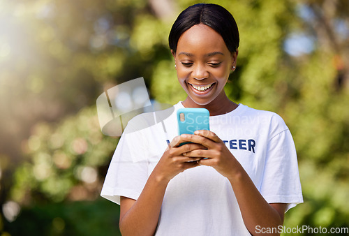 Image of Smile, park volunteering and black woman with a phone for social media, chat or communication. Happy, web and African volunteer or charity worker in nature for cleaning with a mobile for notification