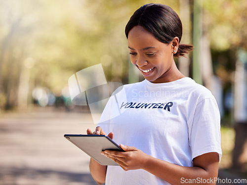 Image of Woman, tablet and volunteering in park on social media FAQ, blog or community service website. African person on digital technology for earth day information, NGO or nonprofit sign up in nature