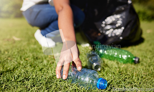 Image of Volunteer, hands and plastic or cleaning park, community service and recycling for climate change or earth day project. Person volunteering in garden or grass with eco friendly action, bottle and bag