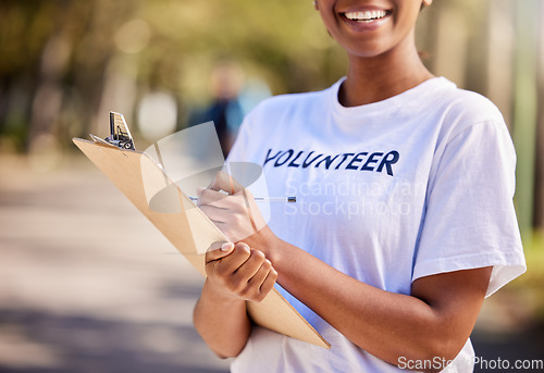 Image of Woman, hands and volunteering checklist in nature for climate change, inspection and community service. Happy person writing on clipboard for earth day, NGO registration or nonprofit sign up in park