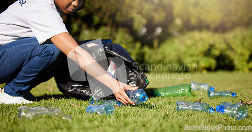 Image of Volunteer, hands and plastic or waste in park, community service and recycling for climate change or earth day project. Person volunteering outdoor or garden for eco friendly cleaning, bottle and bag