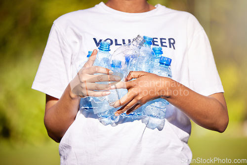 Image of Volunteer hands, plastic bottle and park for community service, recycling and climate change or earth day project. Person volunteering outdoor or nature for eco friendly cleaning or nonprofit support