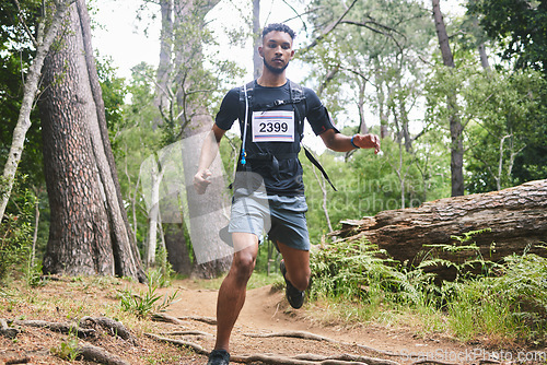 Image of Running, fitness and man in nature for exercise, marathon training and cardio workout. Sports, nature and athlete in woods for wellness, healthy body and endurance for race, challenge and competition