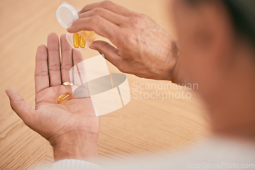 Image of Person, hands and pills in medication, illness or omega tablets for joint or muscle pain on desk at home. Closeup of patient taking drugs or capsules in container for healthcare, antibiotics or cure