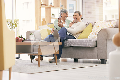 Image of Happy elderly couple, phone and relax on sofa in living room for social media or entertainment at home. Mature man and woman smile on mobile smartphone app together in happiness on couch in house