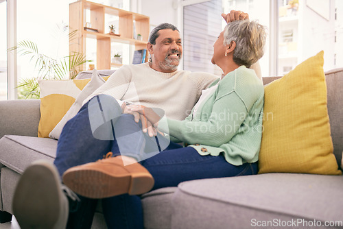 Image of Love, mature couple and relax on sofa in home for romance, care and bonding together with marriage partner. Man, woman and talk on couch with smile, support or loyalty for relationship in living room