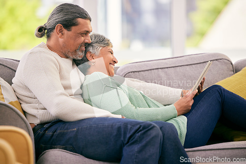 Image of Tablet, mature couple and relax on sofa for streaming a funny, comedy show, movie or video together in lounge. Happy, man and woman in retirement with social media or mobile app for communication