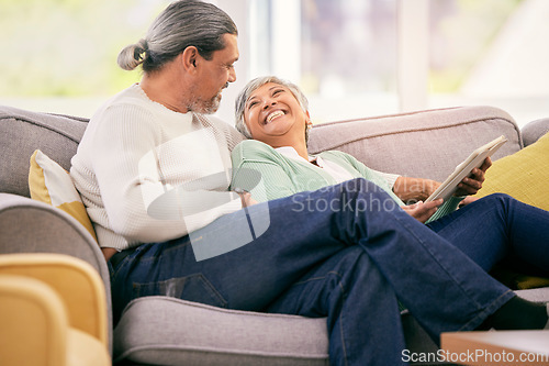 Image of Happy, mature couple and tablet on sofa to relax with streaming a funny, comedy show or movie together in lounge. Love, man and woman in retirement laughing with mobile app or conversation in home