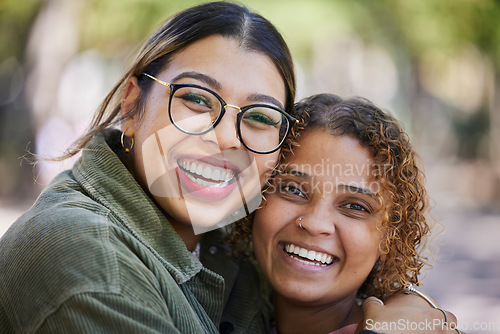 Image of Smile, portrait and women hug at a park outdoor for weekend, bonding or hanging out or having fun together. Happy, face and female friends embrace, excited and cheerful for reunion, trip or vacation