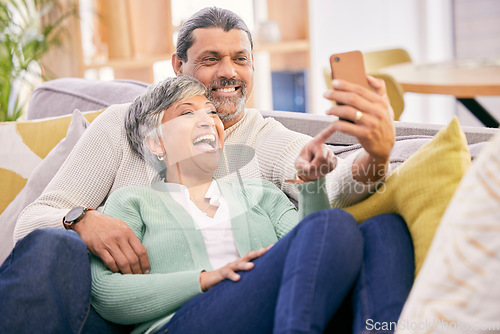 Image of Mature couple, laugh and phone in home of social media post, meme or mobile app subscription. Happy man, woman and reading funny joke on internet, scroll on smartphone or relax on sofa in living room