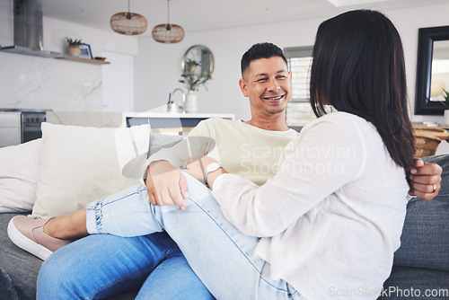 Image of Conversation, relax and couple on a sofa in the living room talking and bonding together at home. Happy, love and husband speaking and resting with his wife in the lounge of their modern house.