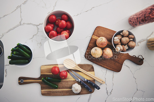 Image of Cooking, food and top view of vegetables in kitchen on wood board for cutting, meal prep and nutrition. Healthy diet, ingredients and above of tomato, onions and mushrooms for dinner, lunch or supper