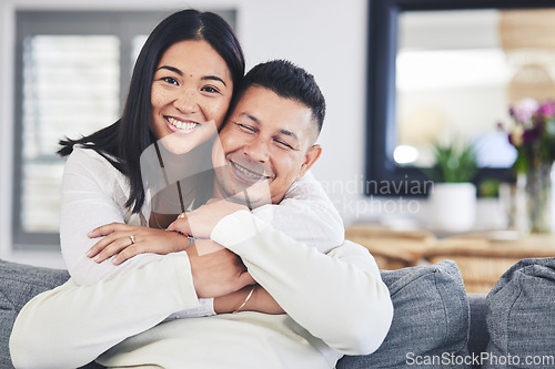 Image of Happy, portrait and woman hugging her husband while relaxing on a sofa in the living room. Smile, love and face of an Mexican female person with a man in the lounge of their modern house together.