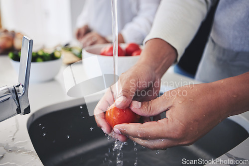 Image of Water, tomato and hands cleaning vegetable for cooking in a kitchen basin or sink in a home for hygiene as a chef. Salad, food and person prepare produce for a supper, lunch or dinner for diet meal