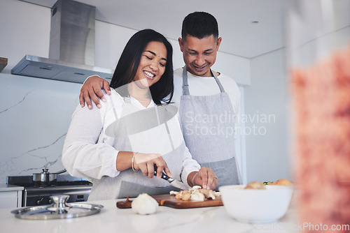 Image of Hug, cooking and love with couple in kitchen for food, health and lunch recipe. Happy, nutrition and dinner with man and woman cutting vegetables at home for diet, wellness and romance together