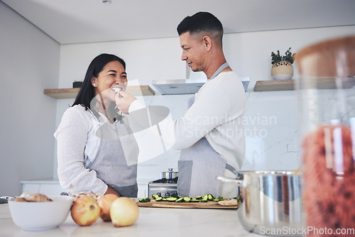Image of Feeding, cooking and love with couple in kitchen for food, health and lunch recipe. Happy, nutrition and dinner with man and woman cutting vegetables at home for diet, wellness and romance together