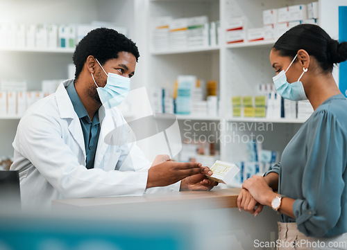 Image of Pharmacist, patient and face mask with box in consultation, healthcare advice or prescription at pharmacy. Man or medical professional explaining over counter medication to sick customer at drugstore