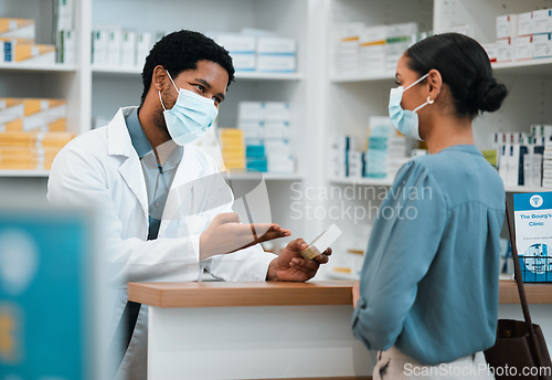 Image of Pharmacist, face mask or black man giving pills to woman patient in customer service for wellness advice. Healthcare help, African pharmacy or doctor with pharmaceutical medicine or medical product